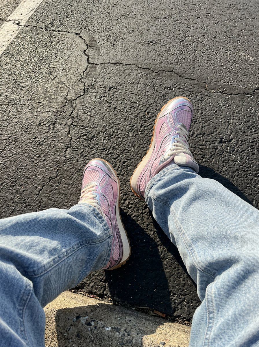 Pink PRX-01 on a sunny curb, light-wash baggy jeans