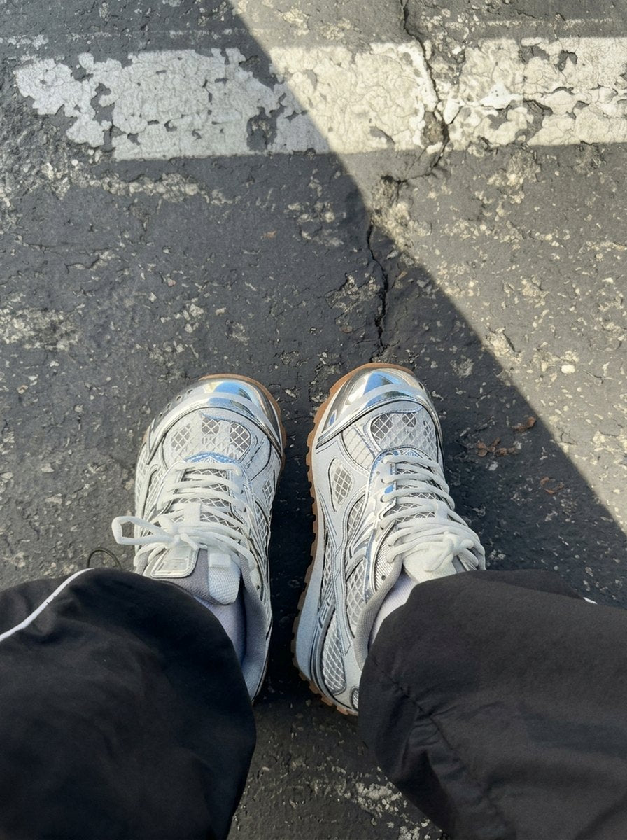 Silver PRX-01 on a parking lot, black baggy pants